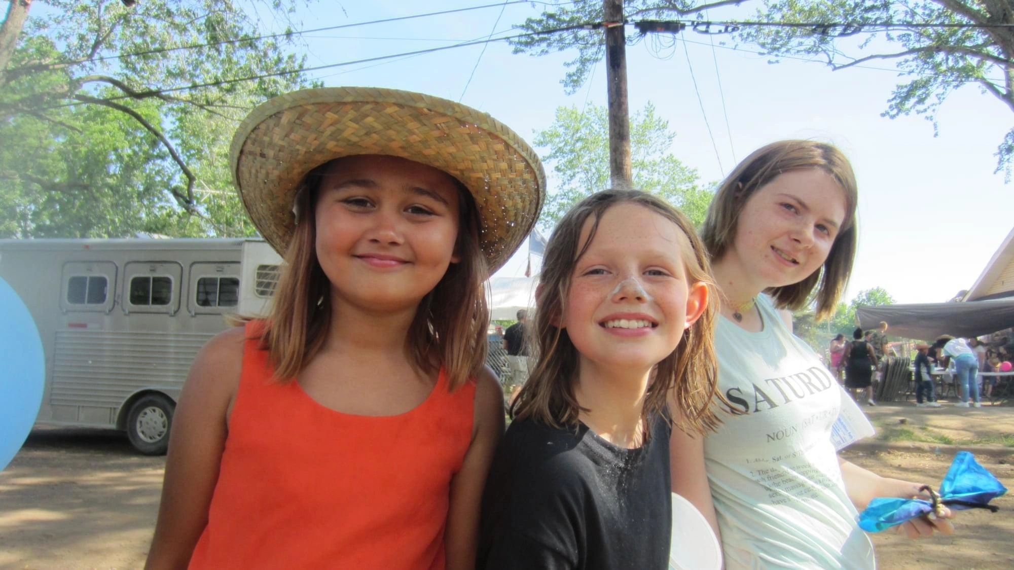 Three girls smiling at outdoor event