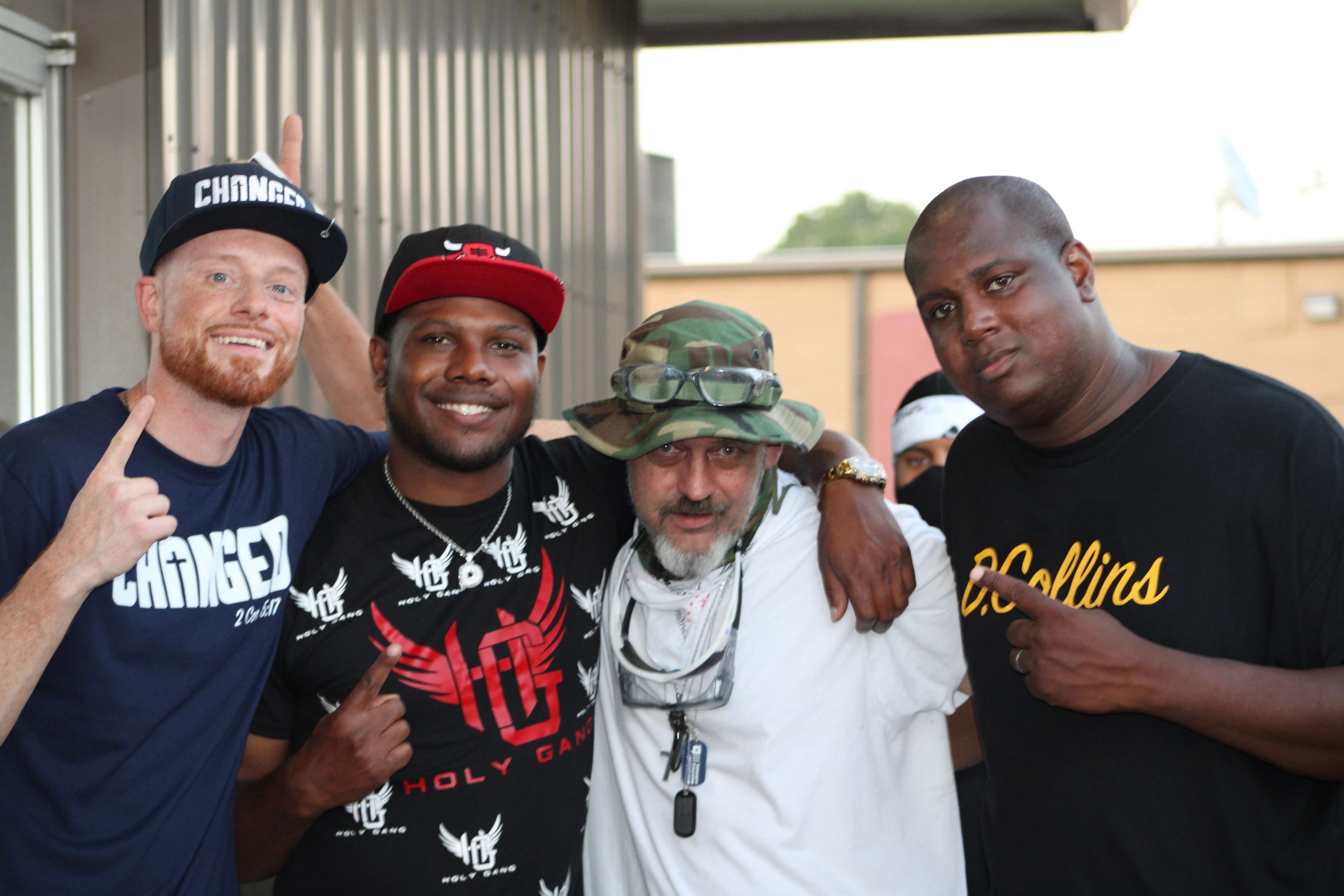 Four men posing together outdoors