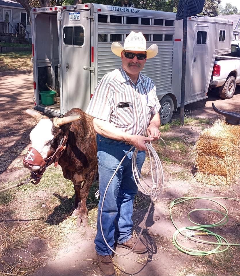 Man in western attire with goat
