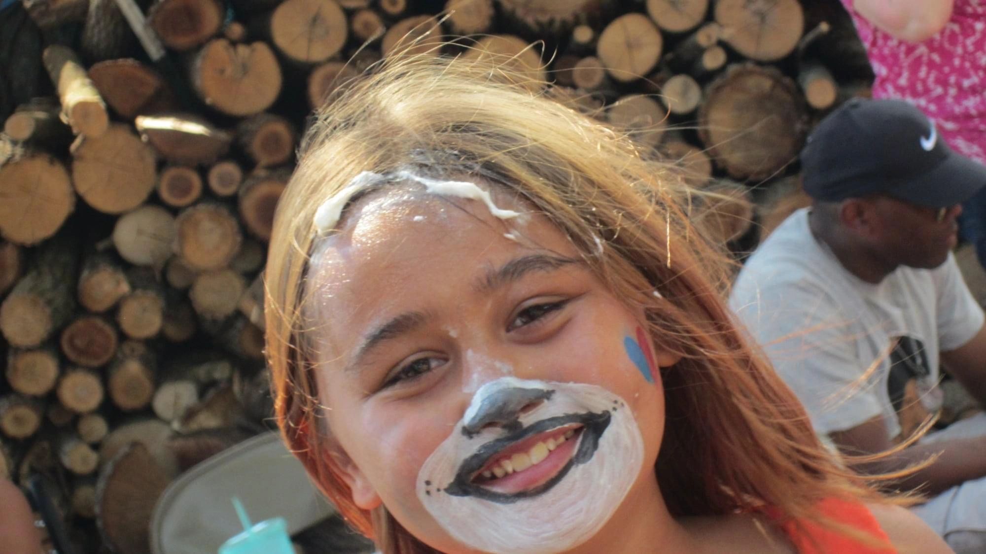 Child with face paint smiling